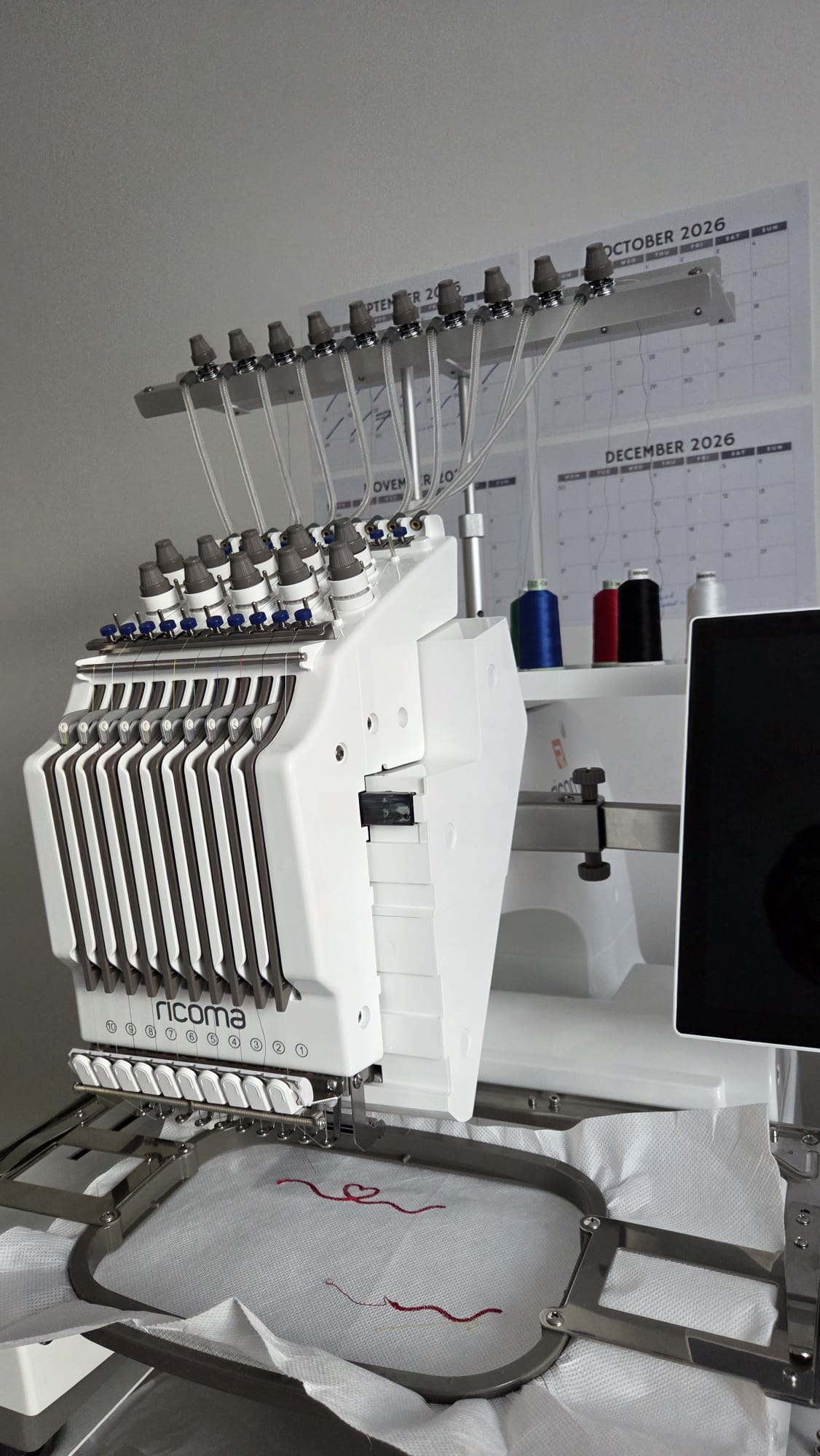 Our Ricoma embroidery machine stitching a custom design in the studio